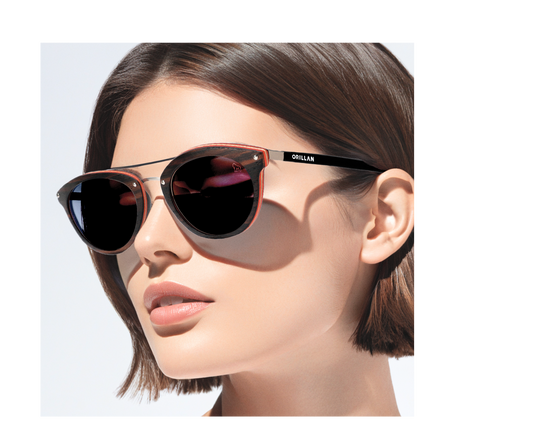 Closeup of female dark hair model wearing handcrafted wooden sunglasses by ORILLAN. Round shape frames in dark brown color, silver colored metal details and dark grey polarized lenses - Eco-friendly eyewear collection with minimalistic Scandinavian design – ORILLAN Sweden